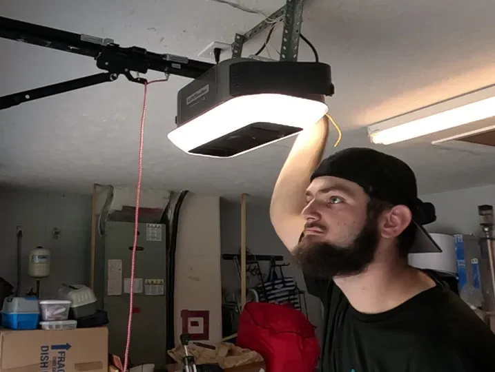 Professional technician performing an Opener Installation in a residential garage.